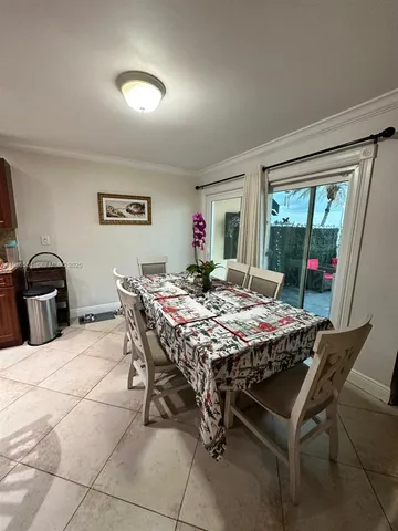 a very nice looking dining room with a table and chairs