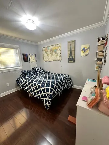 a bedroom with bed and a chandelier