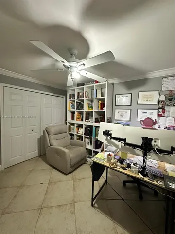 a living room with furniture a rug and white walls