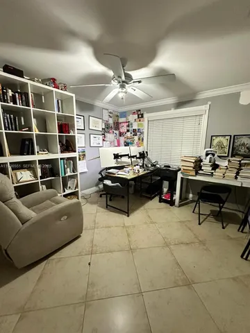 a living room with furniture and a book shelf