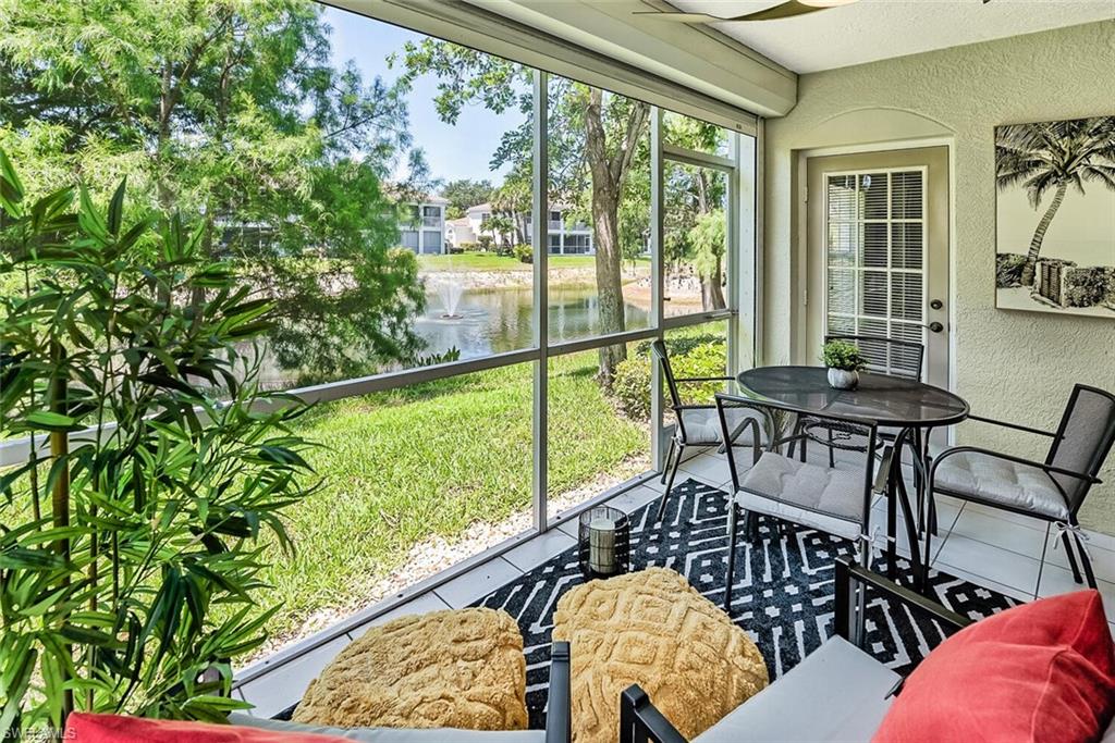6910 Satinleaf Road North, Unit 101 Naples, FL 34109 - Photo 21 of 30 Sunroom featuring a water view