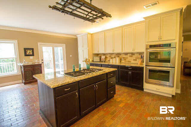 128 Lakeview Loop Daphne, AL 36526 - Photo 13 of 43 5 burner gas cook top in isand, notice double ovens, french doors open to back deck