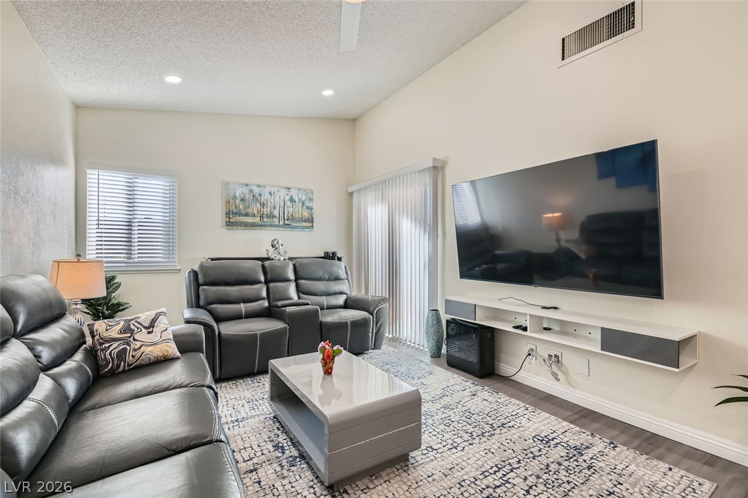 3665 Bronco Road Las Vegas, NV 89103 - Photo 6 of 28 A contemporary living area presents soaring vaulted ceilings and rich wood flooring.