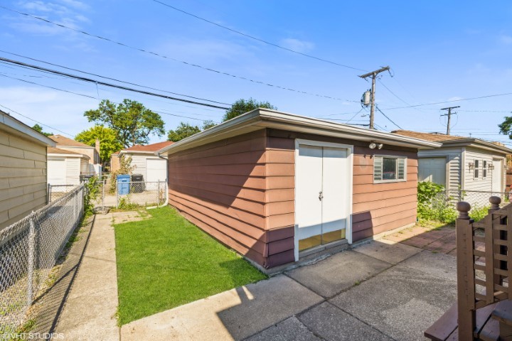 5408 South Rutherford Avenue Chicago, IL 60638 - Photo 13 of 15 a front view of a house with a yard