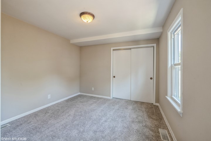 5408 South Rutherford Avenue Chicago, IL 60638 - Photo 9 of 15 an empty room with windows and closet