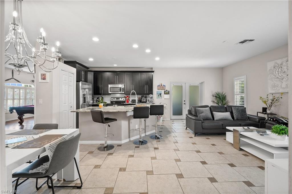 2017 Cape Coral Parkway West Cape Coral, FL 33914 - Photo 16 of 35 Living room featuring recessed lighting, pool table, a chandelier, and baseboards