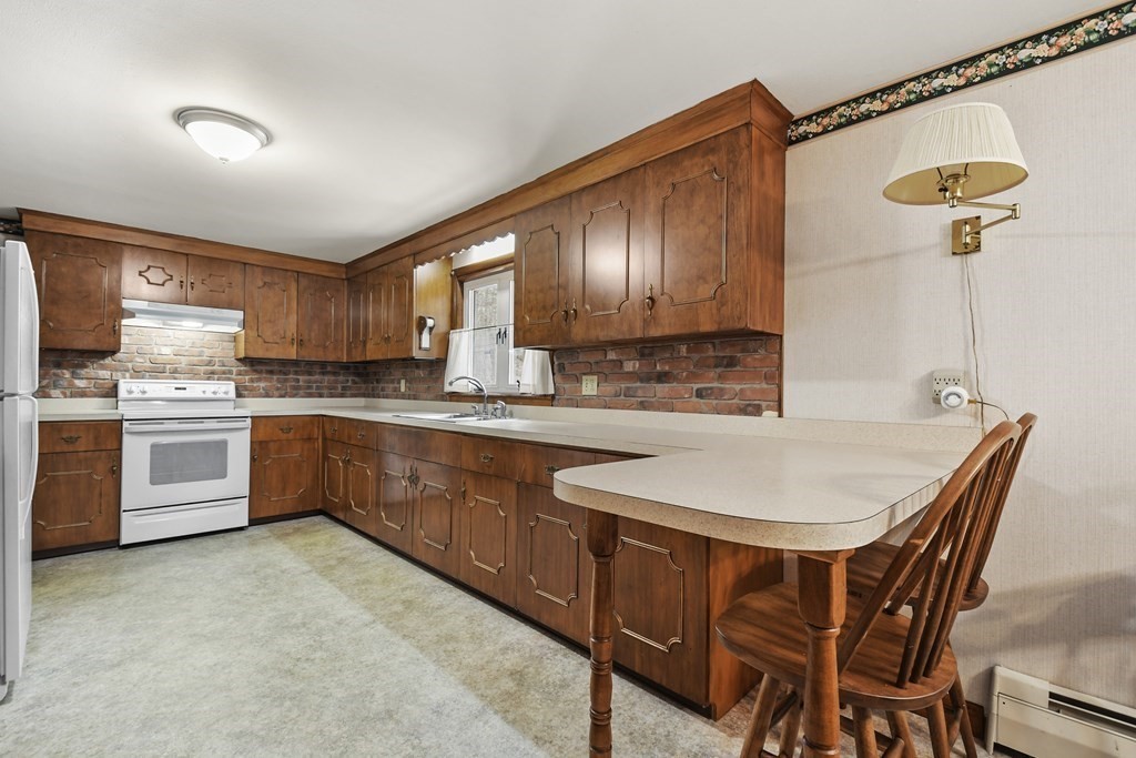 179 State Road Templeton, MA 01436 - Photo 7 of 22 a kitchen with stainless steel appliances granite countertop a sink a stove a refrigerator with a dining table and chairs