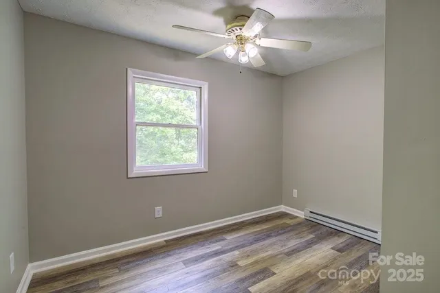 wooden floor in an empty room with a window
