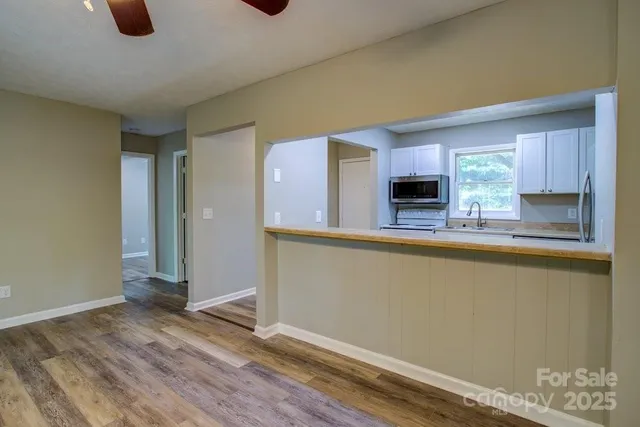 a kitchen with granite countertop a refrigerator and a stove top oven