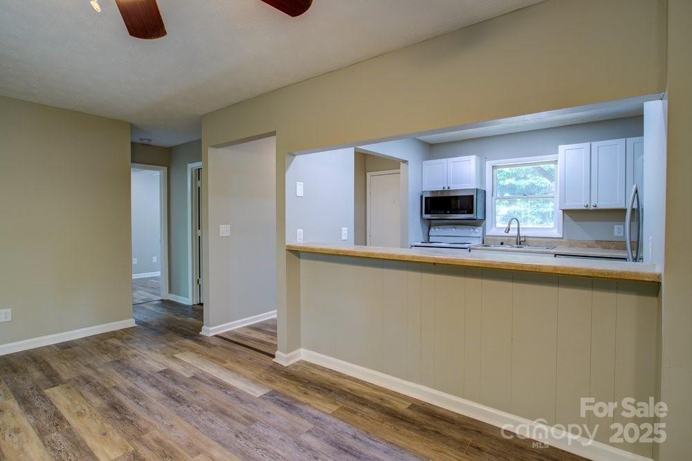 573 Margot Road Boone, NC 28607 - Photo 6 of 15 a kitchen with granite countertop a refrigerator and a stove top oven