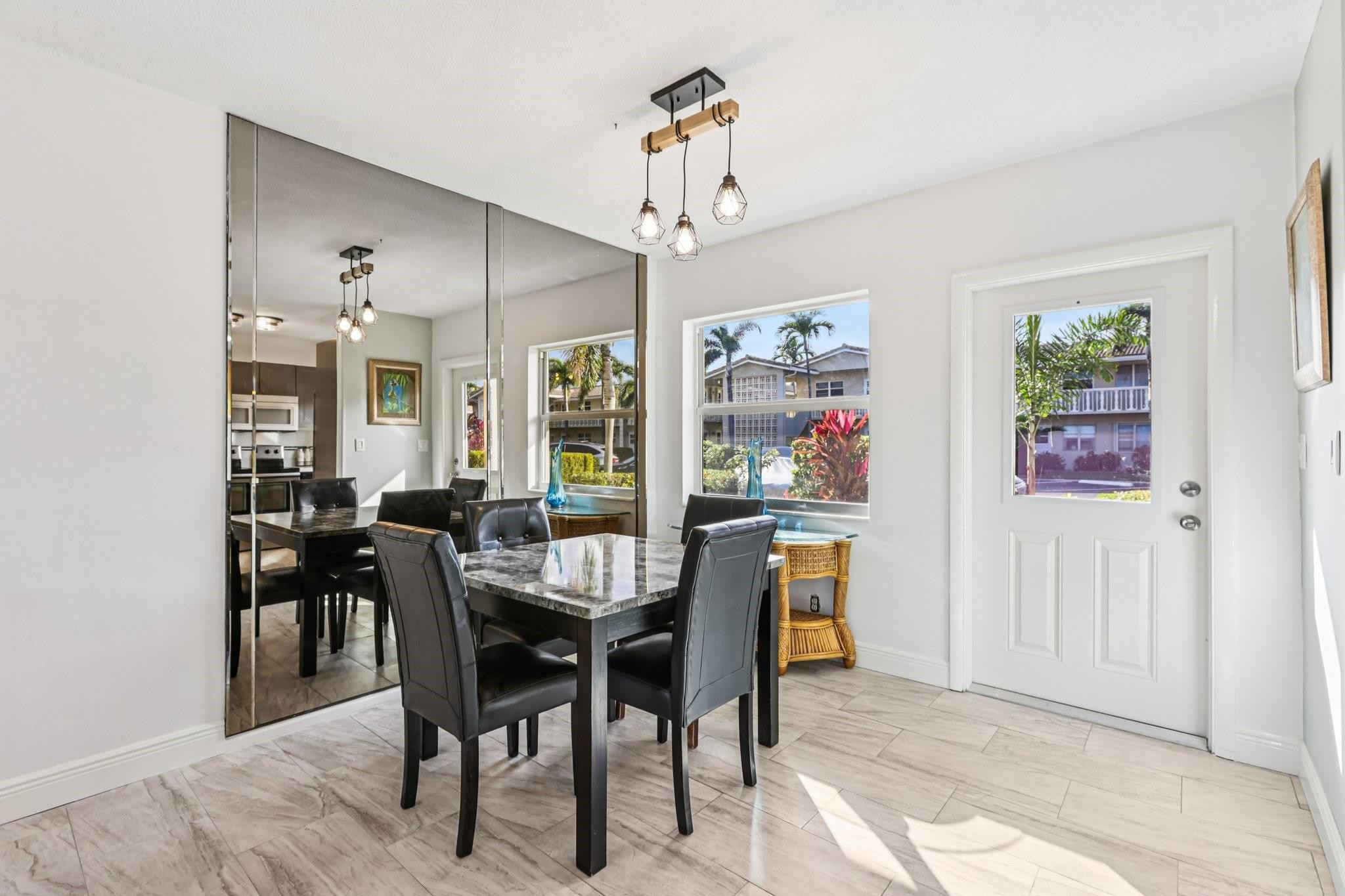 2131 Northeast 42nd Court, Unit 106E Lighthouse Point, FL 33064 - Photo 11 of 33 a view of a dining room with furniture window and outside view