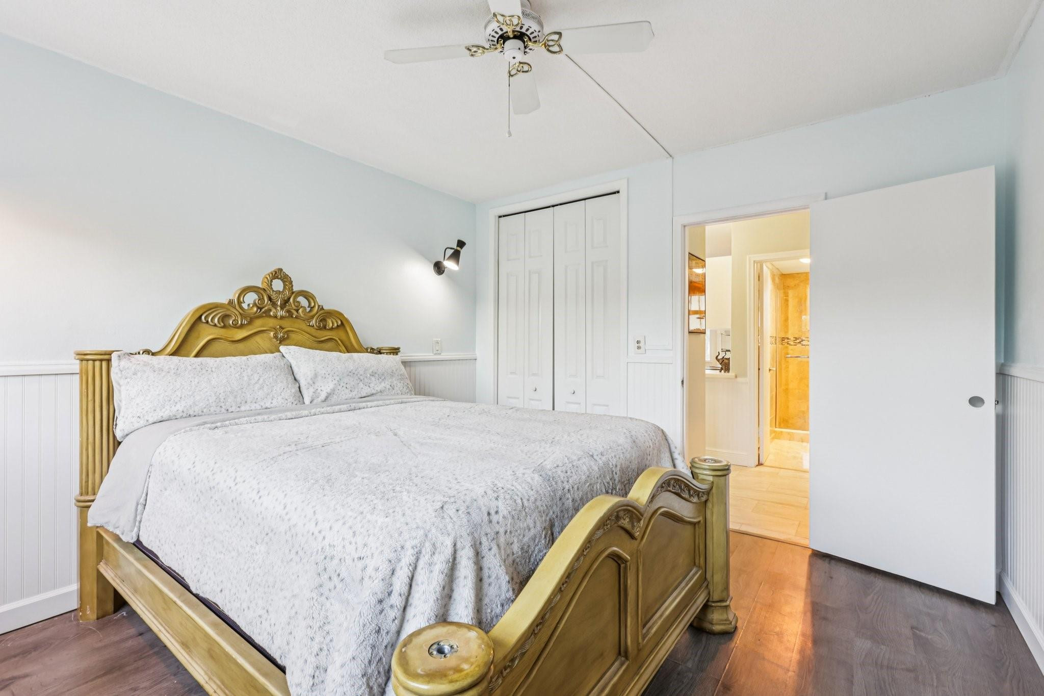2131 Northeast 42nd Court, Unit 106E Lighthouse Point, FL 33064 - Photo 17 of 33 a bedroom with a bed and a chandelier