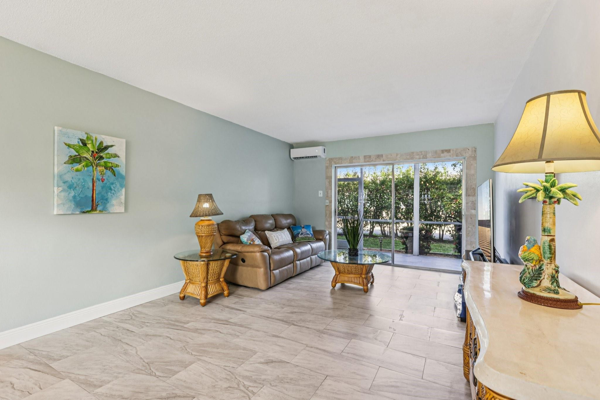 2131 Northeast 42nd Court, Unit 106E Lighthouse Point, FL 33064 - Photo 2 of 33 a living room with furniture and a large window