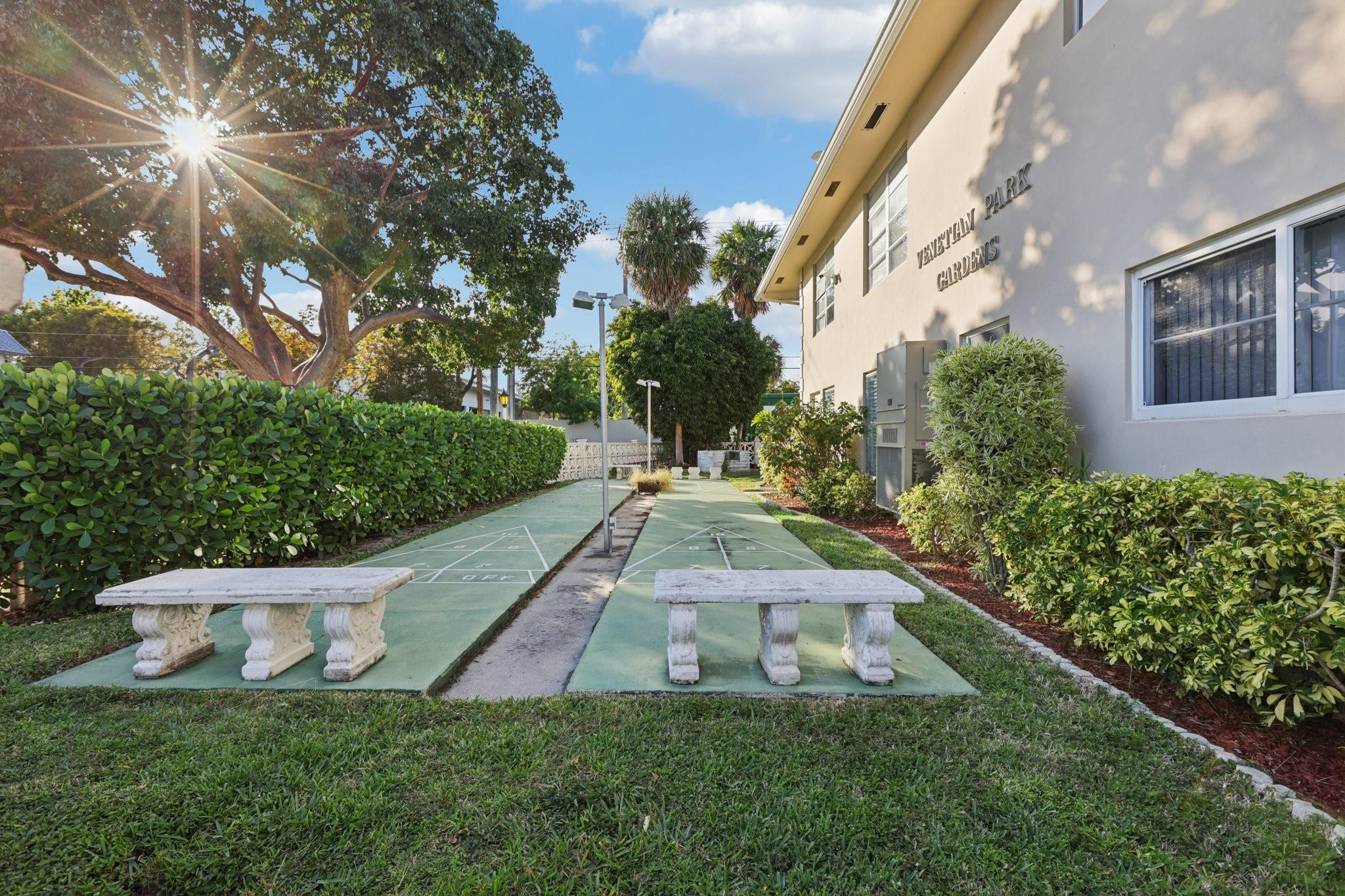 2131 Northeast 42nd Court, Unit 106E Lighthouse Point, FL 33064 - Photo 28 of 33 a view of a backyard with potted plants and large trees