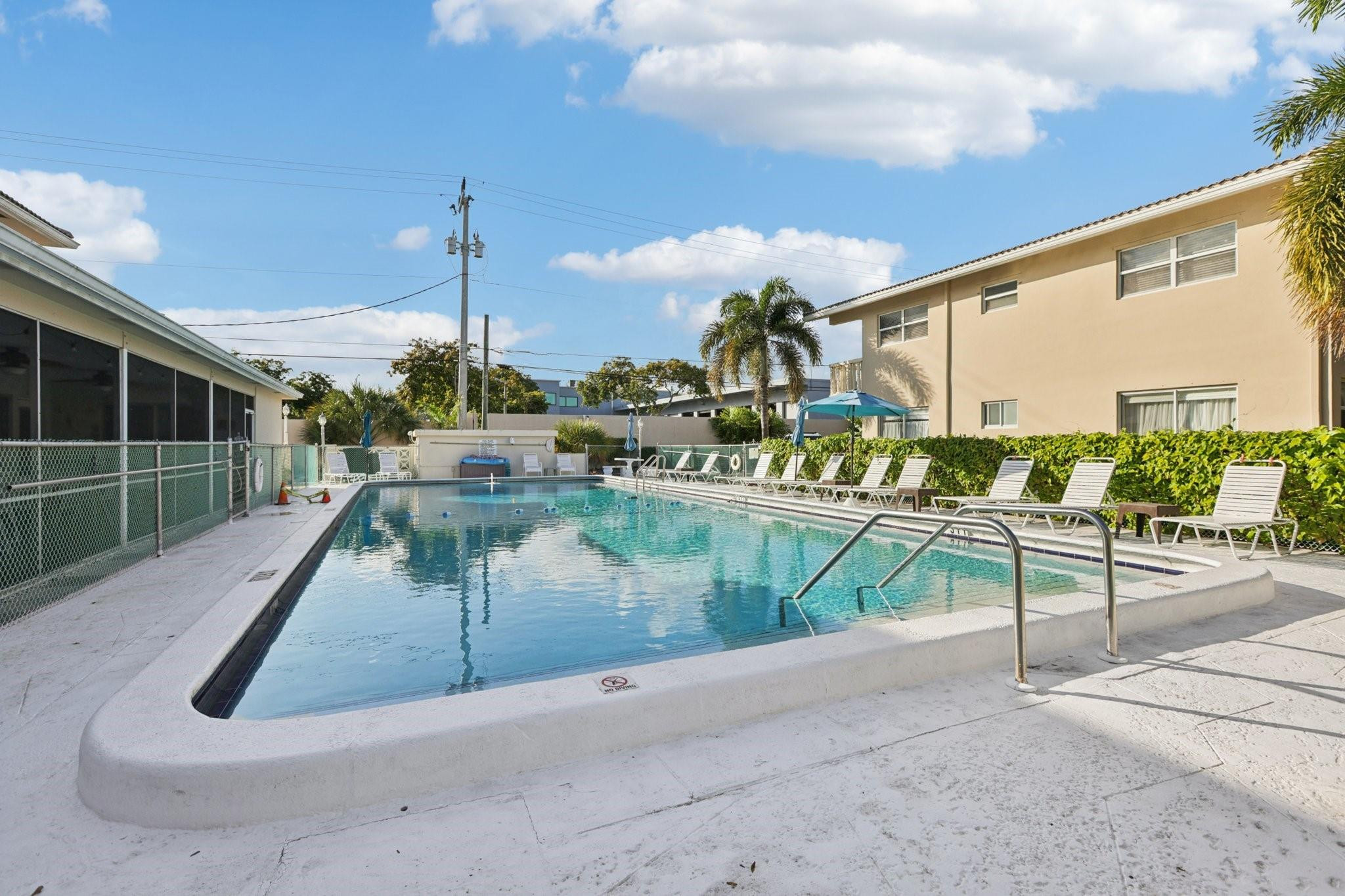 2131 Northeast 42nd Court, Unit 106E Lighthouse Point, FL 33064 - Photo 29 of 33 a view of a swimming pool with a patio