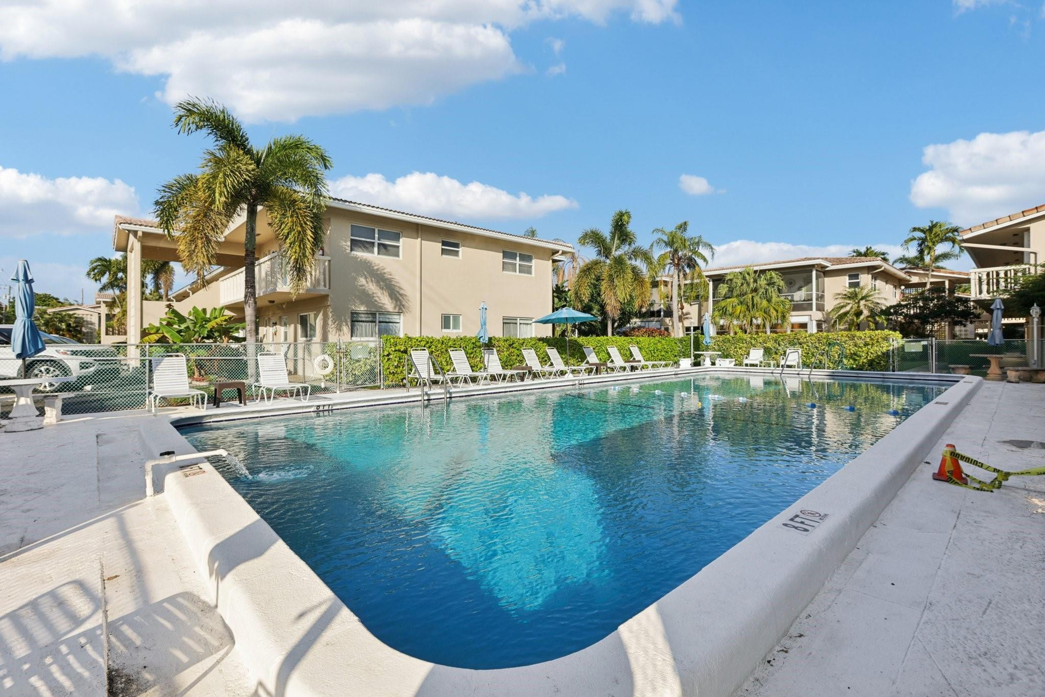 2131 Northeast 42nd Court, Unit 106E Lighthouse Point, FL 33064 - Photo 30 of 33 a view of a swimming pool with a lake view