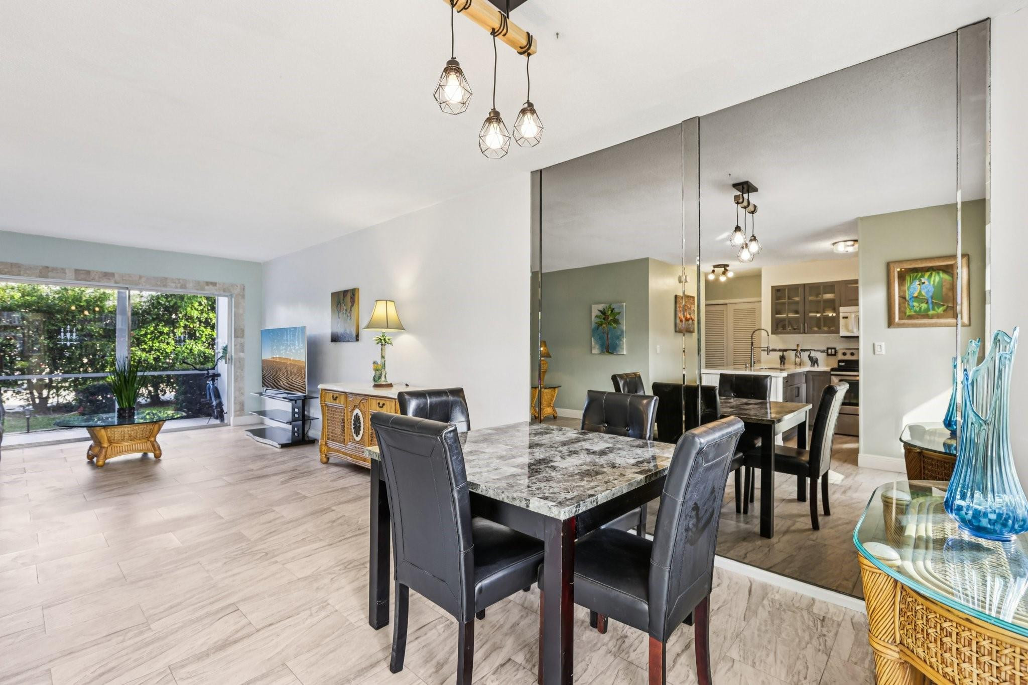 2131 Northeast 42nd Court, Unit 106E Lighthouse Point, FL 33064 - Photo 9 of 33 a view of a dining room with furniture and wooden floor