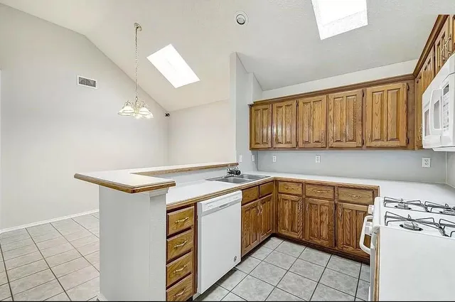 a kitchen with a stove sink and cabinets