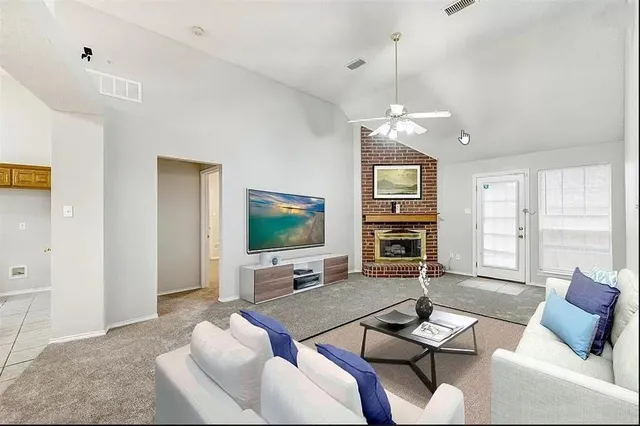 a living room with furniture a flat screen tv and a dining table