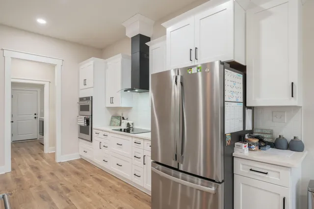 a kitchen with stainless steel appliances a refrigerator sink and cabinets