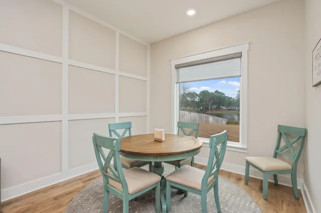 a view of a dining room with furniture window and wooden floor