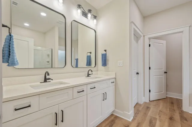 a bathroom with a double vanity sink mirror and