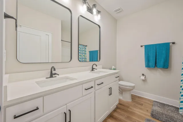 a bathroom with a toilet sink and mirror