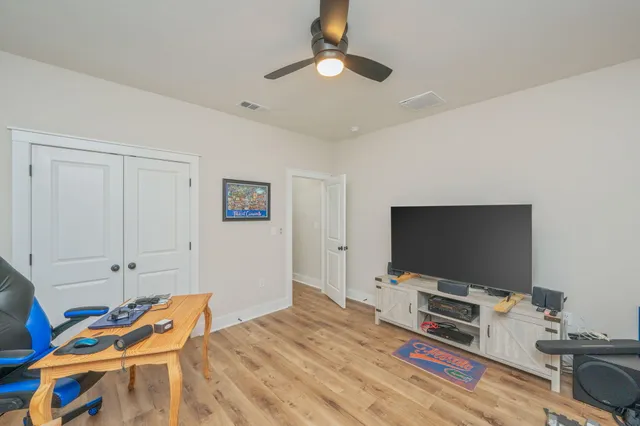 a bedroom with bed and a flat screen tv