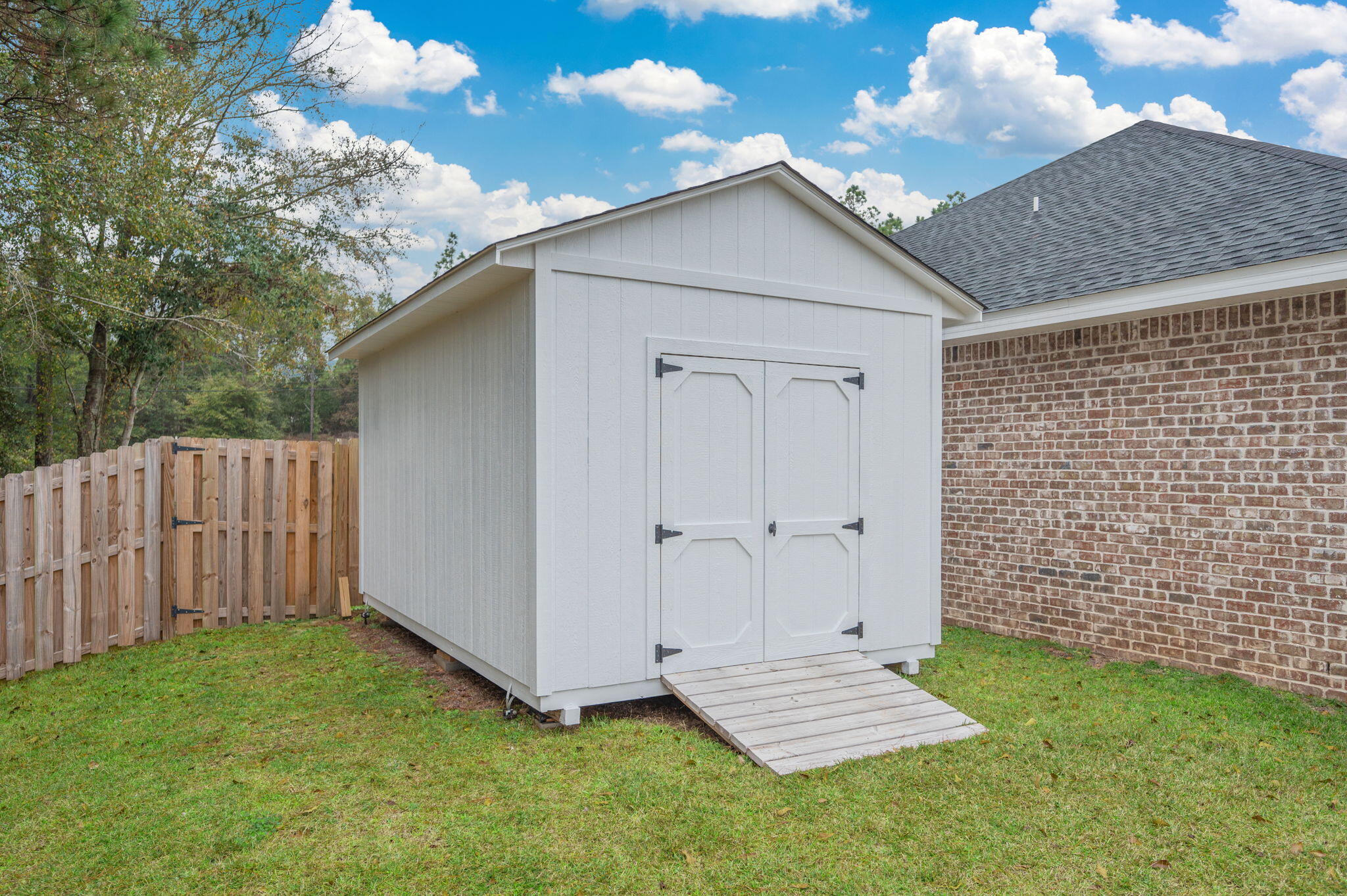 280 Timberline Drive Crestview, FL 32539 - Photo 34 of 46 a view of a backyard with wooden fence and a bench