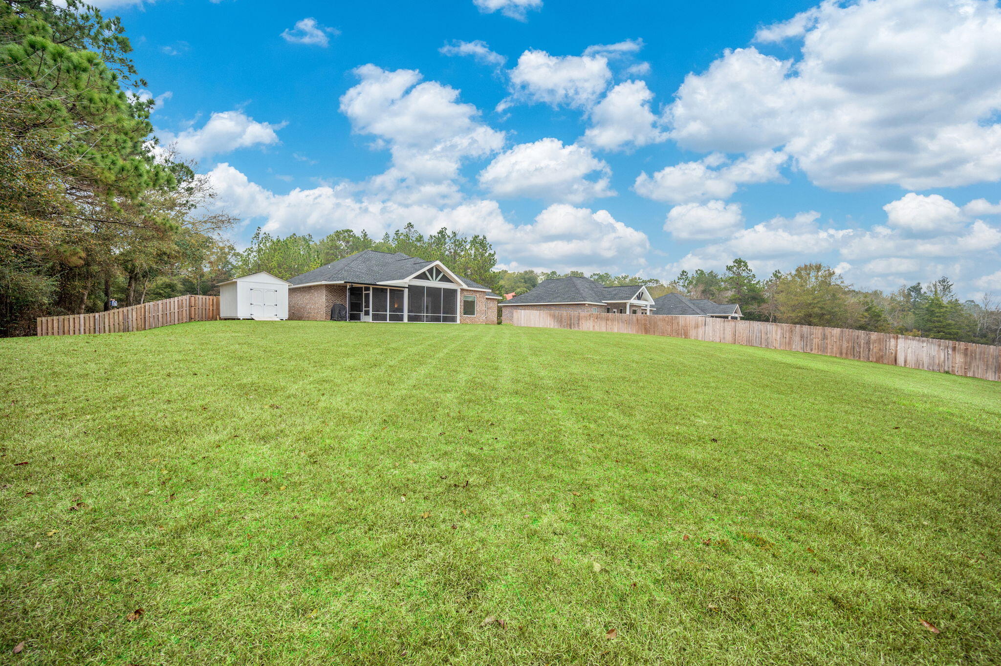 280 Timberline Drive Crestview, FL 32539 - Photo 36 of 46 a view of yard with swimming pool and trees in the background