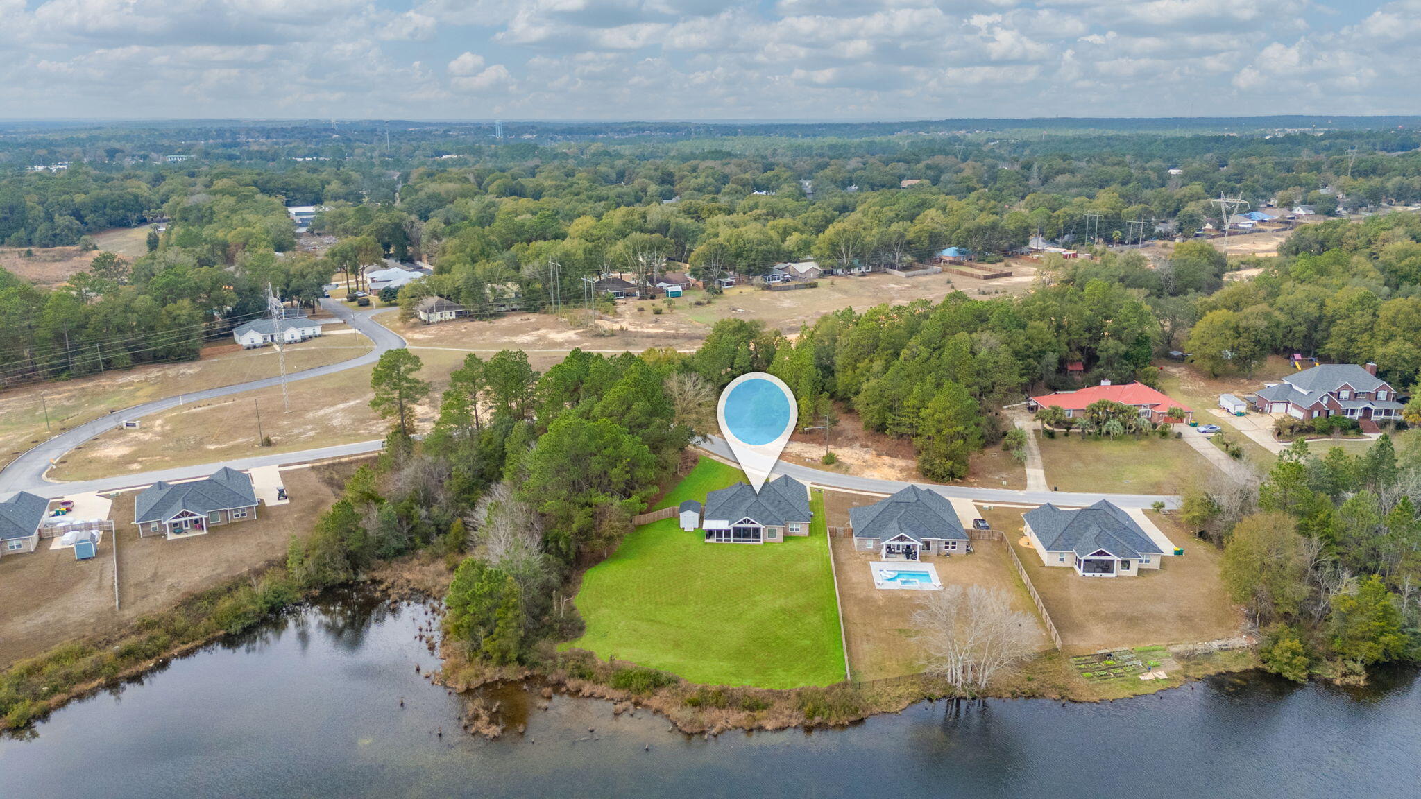 280 Timberline Drive Crestview, FL 32539 - Photo 42 of 46 an aerial view of a house with a garden and lake view
