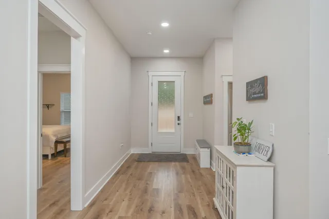 a view of an entryway with wooden floor