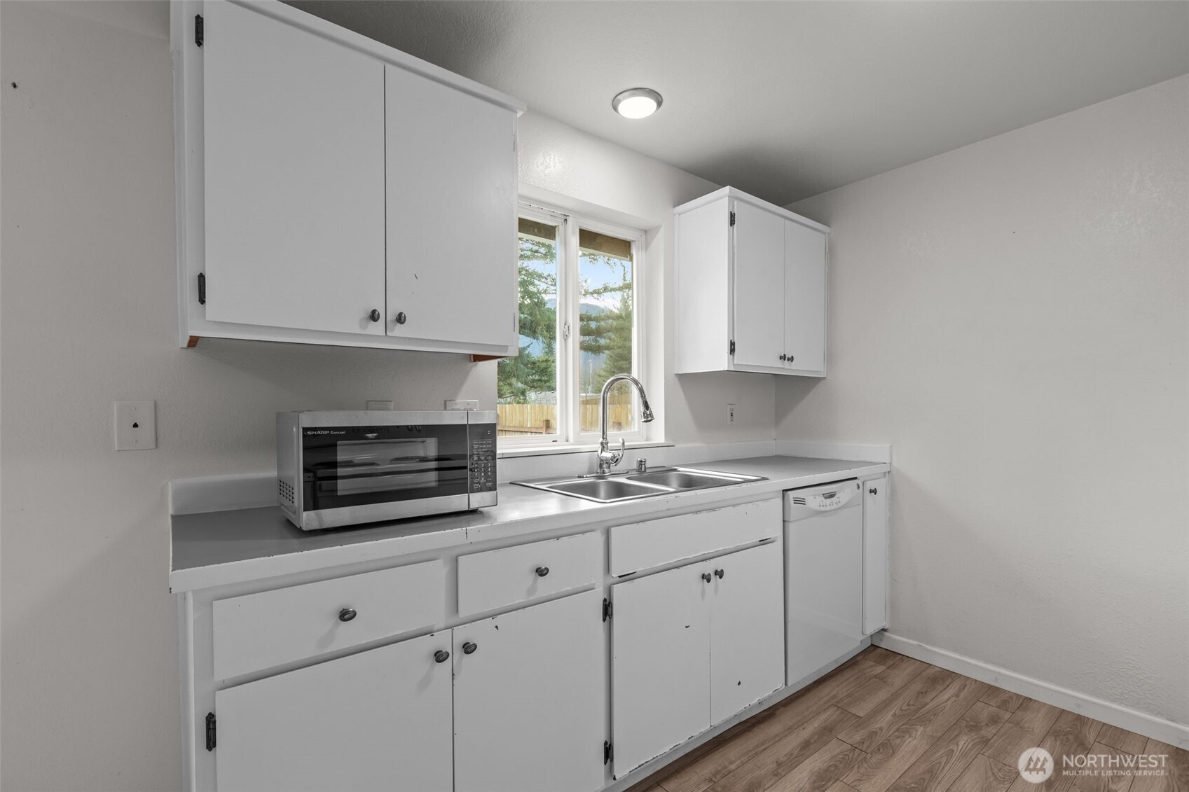 224 7th Street Gold Bar, WA 98251 - Photo 13 of 35 a kitchen with appliances a sink and cabinets