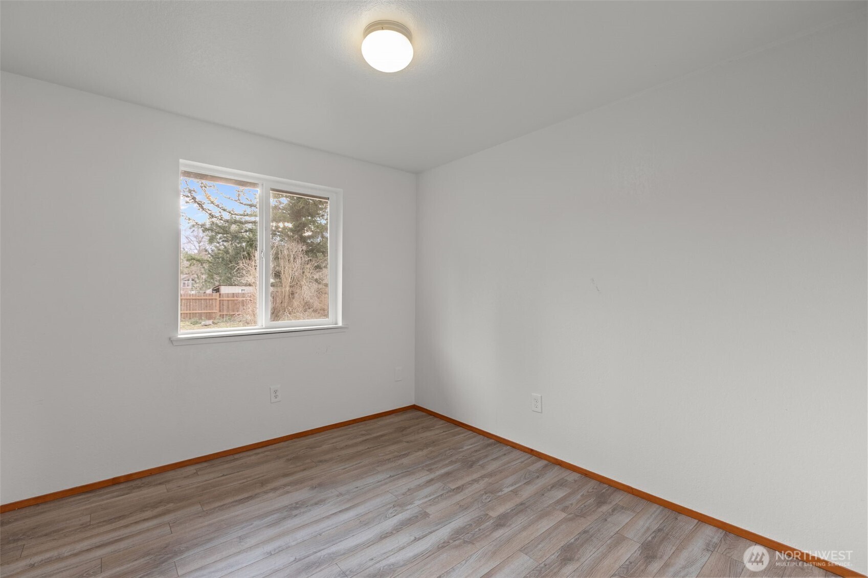 224 7th Street Gold Bar, WA 98251 - Photo 14 of 35 an empty room with wooden floor and windows