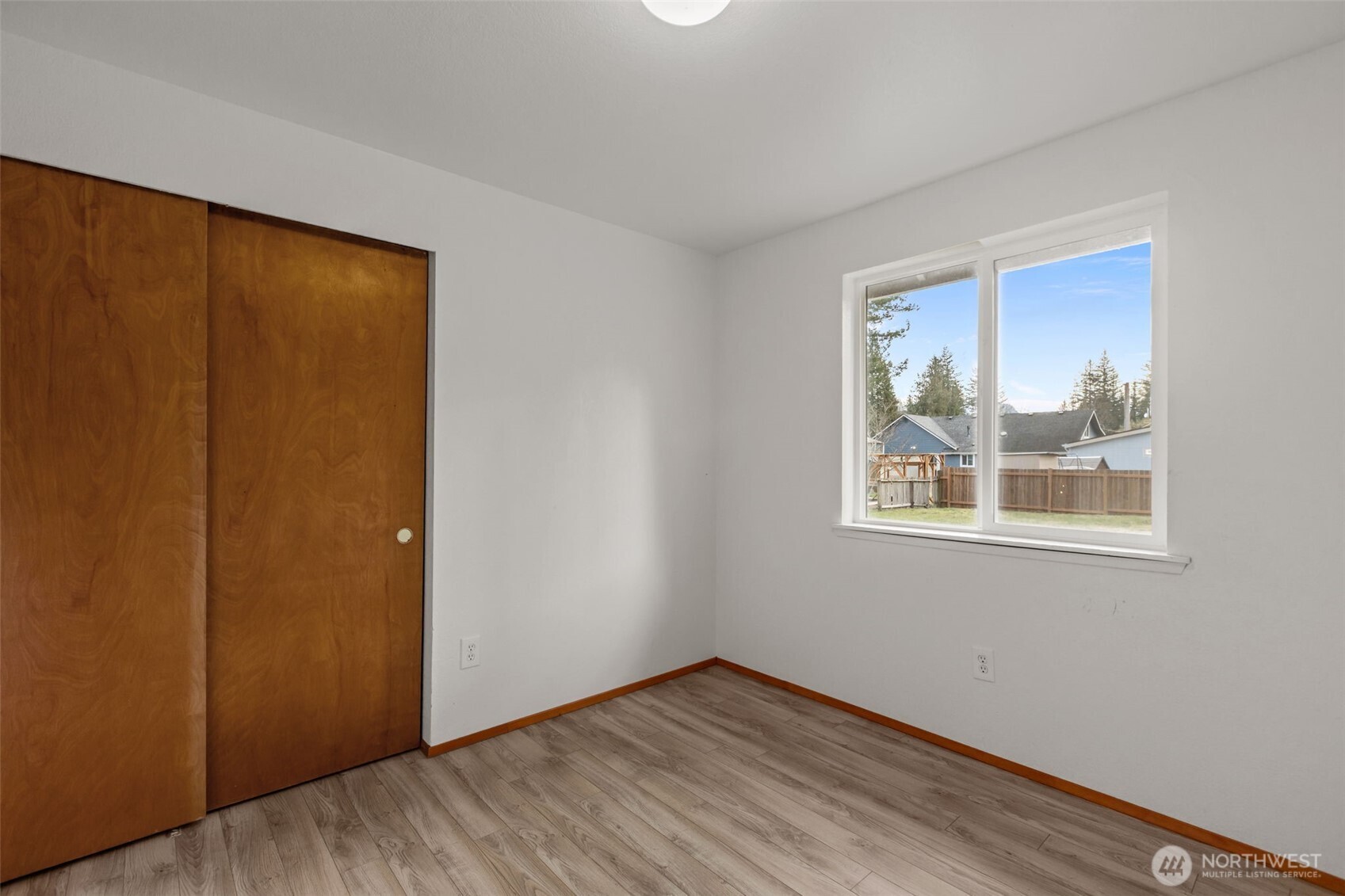 224 7th Street Gold Bar, WA 98251 - Photo 17 of 35 a view of an empty room with wooden floor and a window