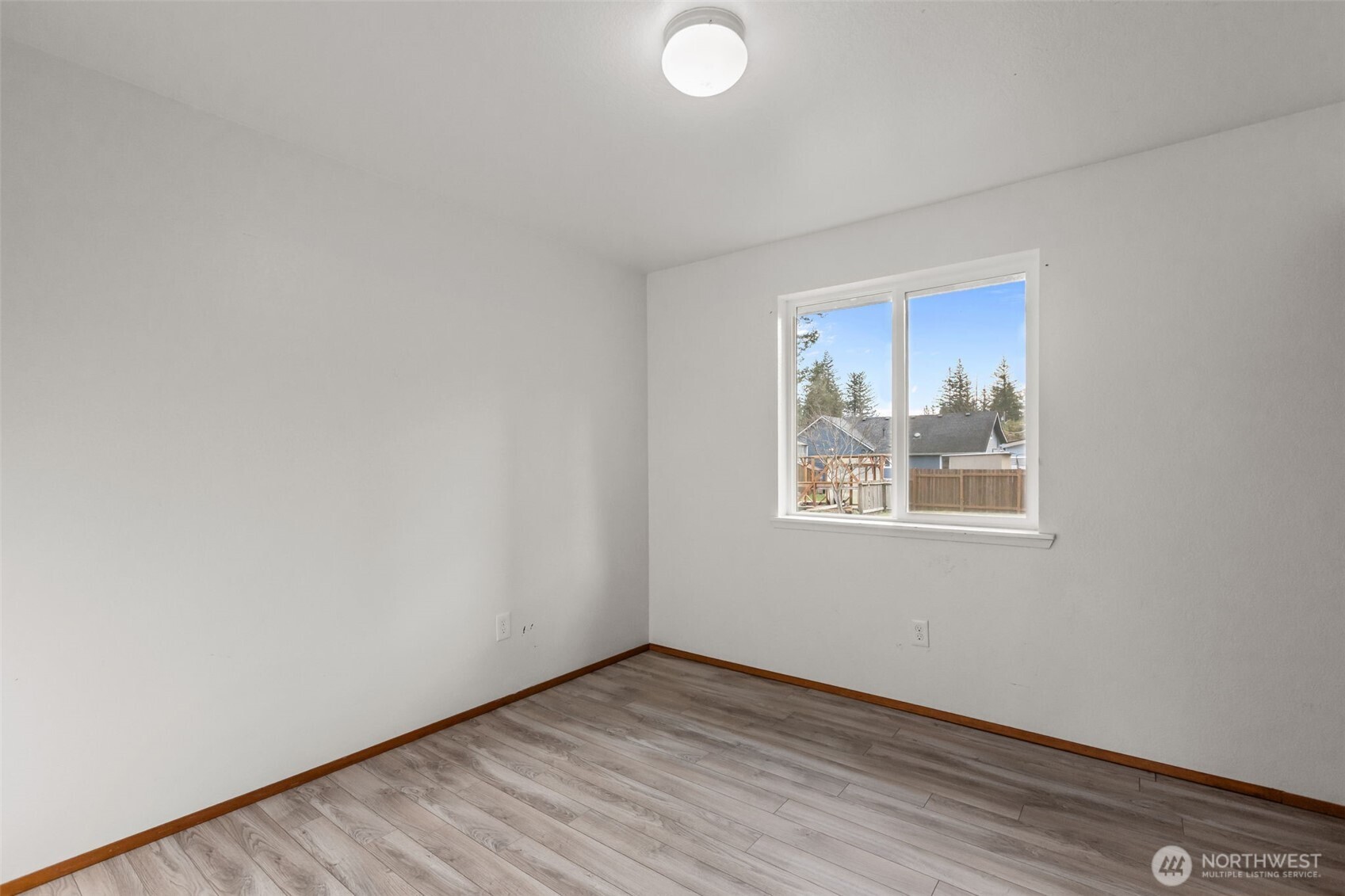 224 7th Street Gold Bar, WA 98251 - Photo 19 of 35 an empty room with wooden floor and windows