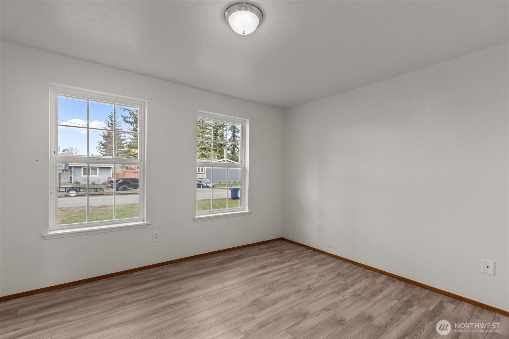 224 7th Street Gold Bar, WA 98251 - Photo 23 of 35 an empty room with wooden floor and windows