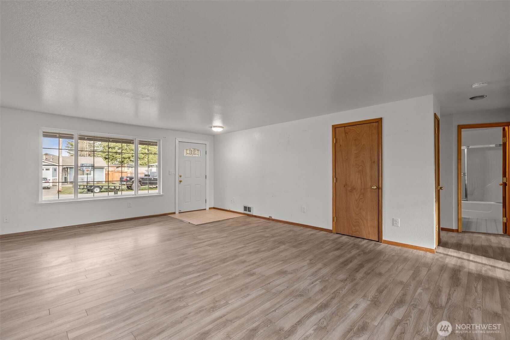 224 7th Street Gold Bar, WA 98251 - Photo 4 of 35 an empty room with wooden floor and windows