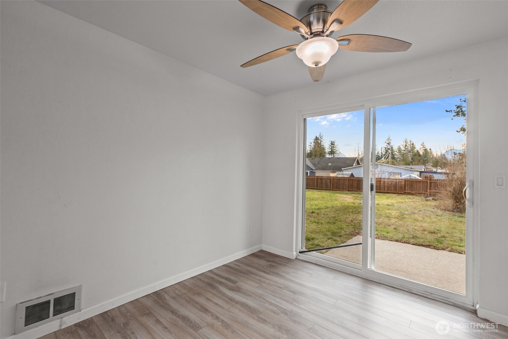 224 7th Street Gold Bar, WA 98251 - Photo 7 of 35 a view of an empty room with a window and wooden floor