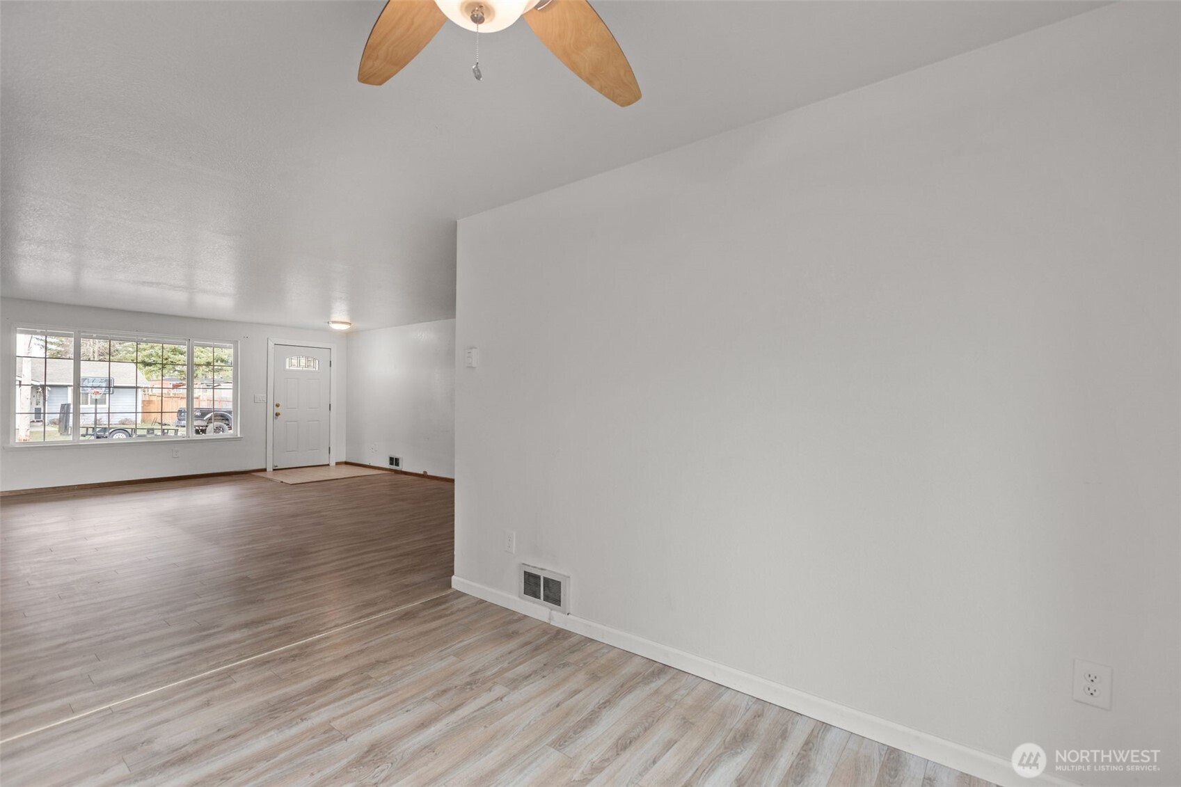 224 7th Street Gold Bar, WA 98251 - Photo 8 of 35 an empty room with wooden floor and windows