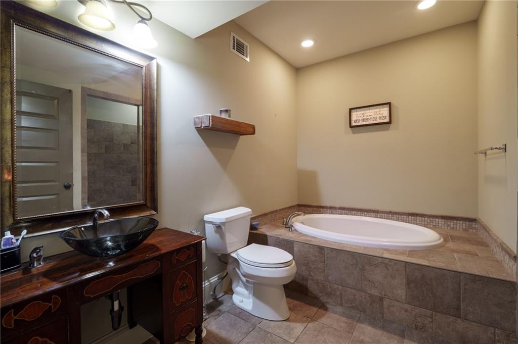723 Sulphur Springs Road Southeast Fairmount, GA 30139 - Photo 32 of 54 a bathroom with a toilet a sink and mirror