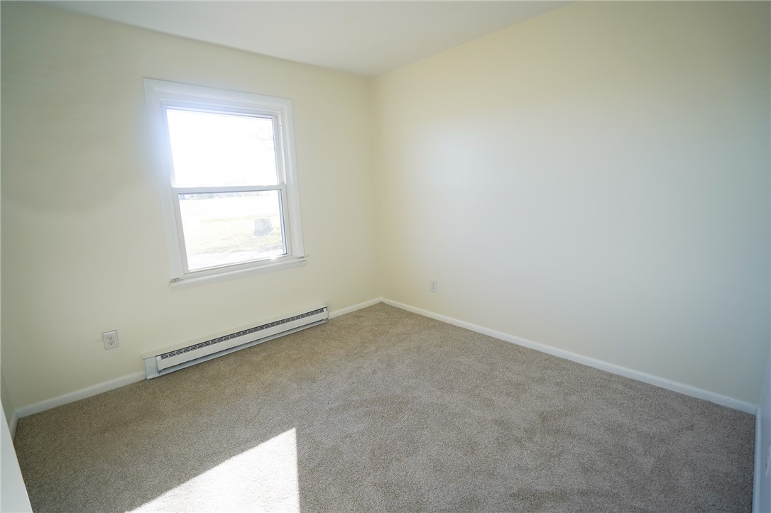 8746 Grubbs-Rex Road Arcanum, OH 45304 - Photo 9 of 38 This cozy room offers abundant natural light and soft carpeting, creating a peaceful living space.