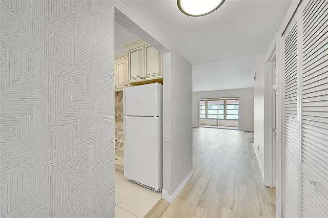 a view of hallway with wooden floor