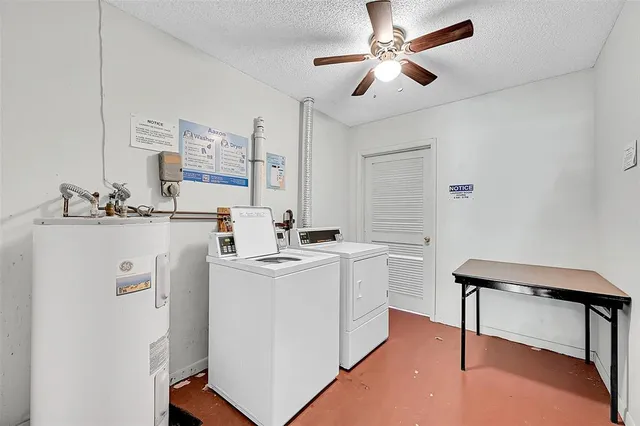 a kitchen with a sink a stove and white cabinets