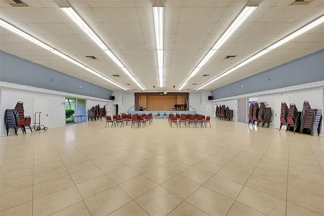 a view of a room with lots of tables and chairs