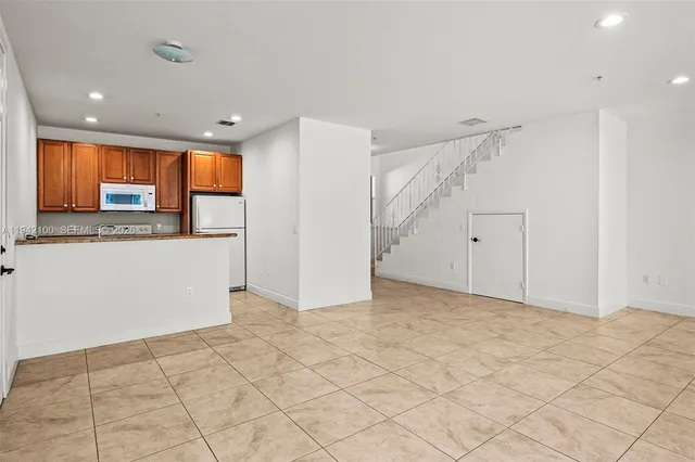a view of a kitchen with a sink and cabinets