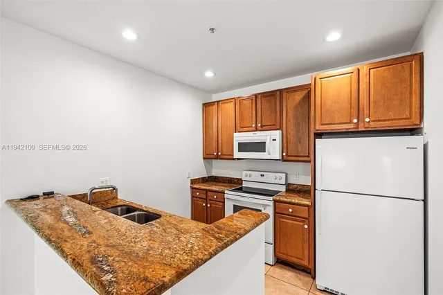 a kitchen with a refrigerator stove and microwave