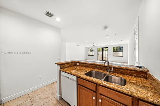a kitchen that has a sink and a stove
