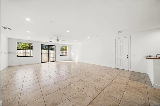 a view of an empty room and a window