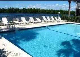 a view of swimming pool with lake and mountain view